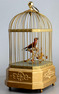 Vintage single singing bird in cage, by Karl Griesbaum