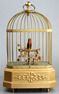 Vintage single singing bird in cage, by Karl Griesbaum