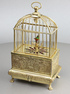 Vintage miniature gilt brass singing bird in cage, by Eschle