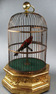 A large Antique hexagonal base antique single singing bird-in-cage, by Bontems