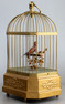 Vintage single singing bird in cage, by Karl Griesbaum