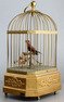 Vintage single singing bird in cage, by Karl Griesbaum