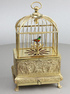 Vintage miniature gilt brass singing bird in cage, by Eschle