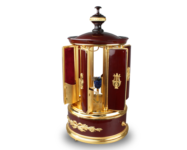 A contemporary maroon lacquer and metal gilt singing bird cigar dispenser carousel, by Reuge