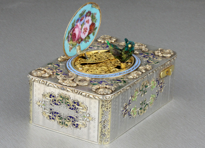 An exceptionally important and early silver, parcel-gilt, enamel and gilt appliques singing bird box, by Charles Bruguier