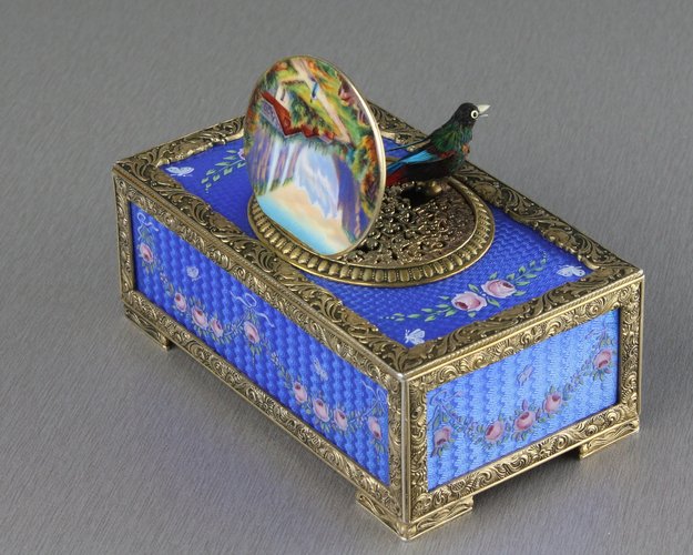 Sterling silver gilt, pictorial and enamel singing bird box with timepiece, movement by C. H. Marguerat