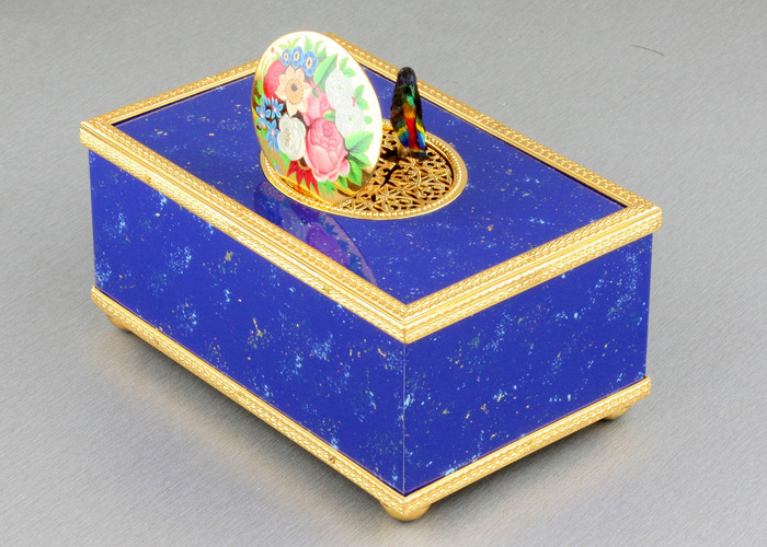 Lapis-lazuli enamelled and gilt musical timepiece alarm-actuated singing bird box, by Reuge