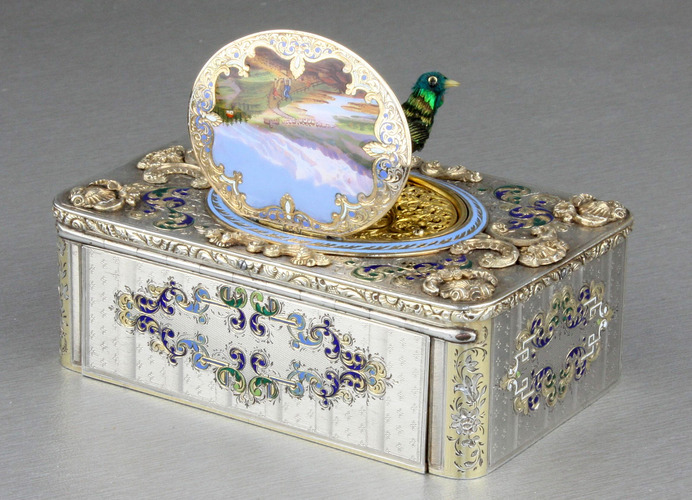 An exceptionally important and early silver, parcel-gilt, enamel and gilt appliques singing bird box, by Charles Bruguier