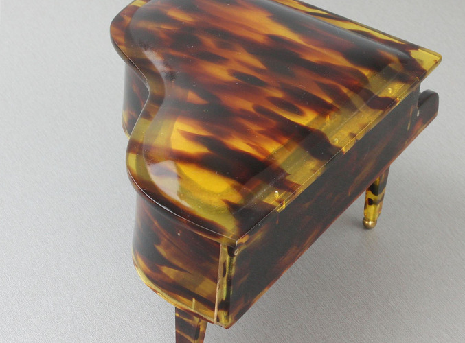 A vintage multi-tone faux tortoiseshell cased grand piano-form musical box