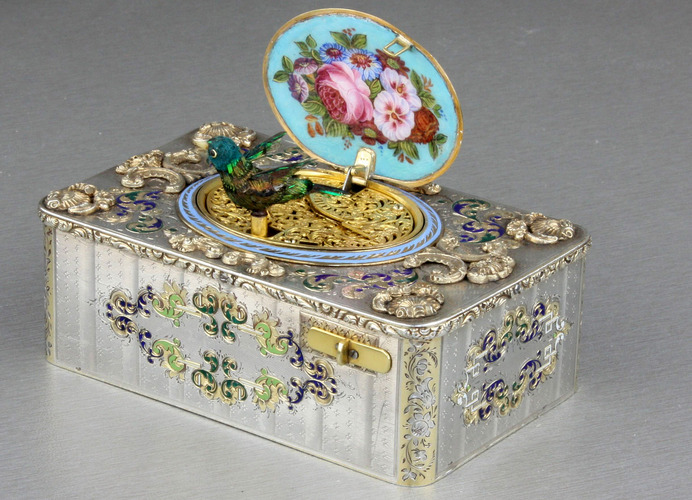 An exceptionally important and early silver, parcel-gilt, enamel and gilt appliques singing bird box, by Charles Bruguier