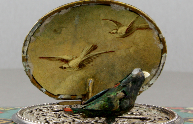 Antique silver and finely painted sarcophagus-form wooden singing bird box, by Juvenia