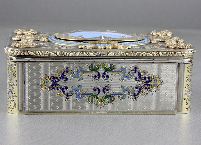 An exceptionally important and early silver, parcel-gilt, enamel and gilt appliques singing bird box, by Charles Bruguier