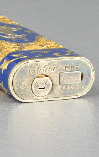 Tooled gilt metal and enamel cigarette lighter, by Cartier