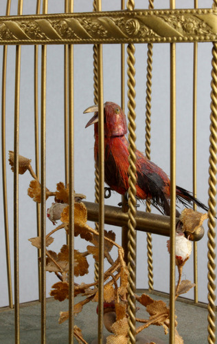 Vintage single singing bird in cage, by Karl Griesbaum