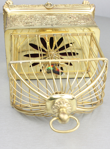 Vintage miniature gilt brass singing bird in cage, by Eschle